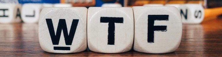 Close up of three wooden cubes with the letters "WTF"