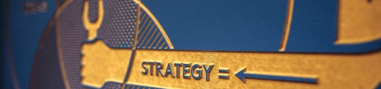 Gold and blue wall plaque with the word "strategy"
